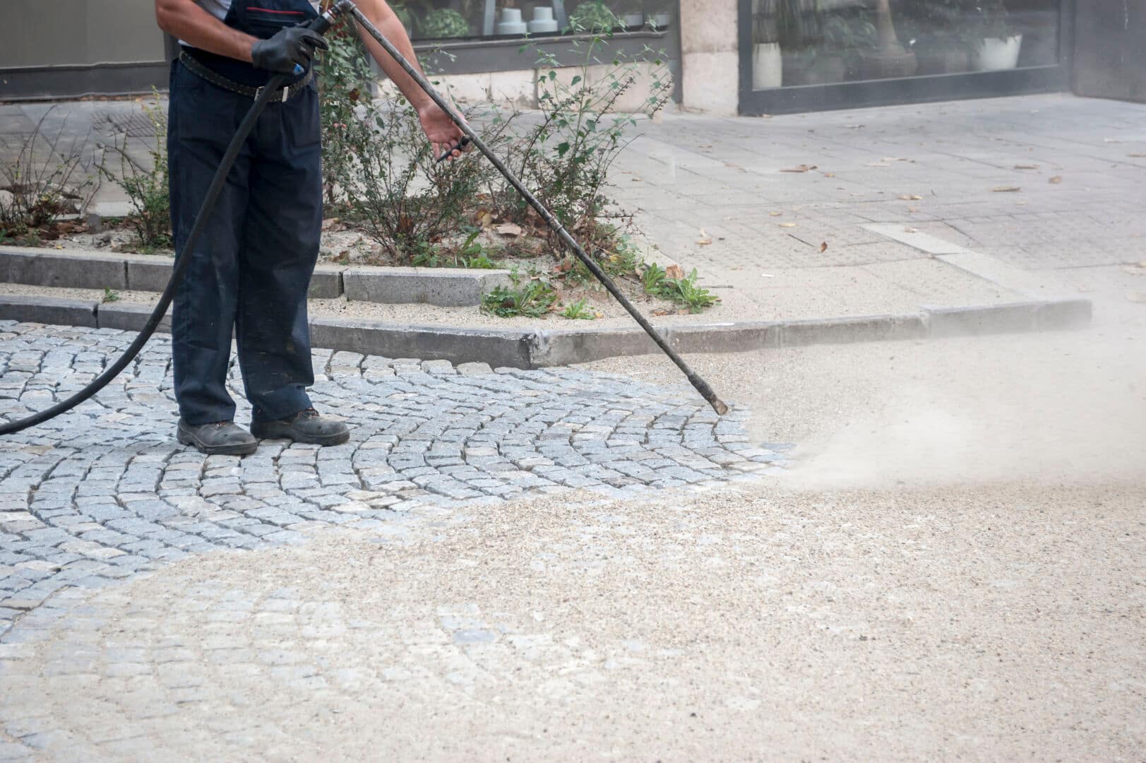 worker, cleaning the streets with a breeze of air How to Choose the Right Pressure Washing Service for Your Needs