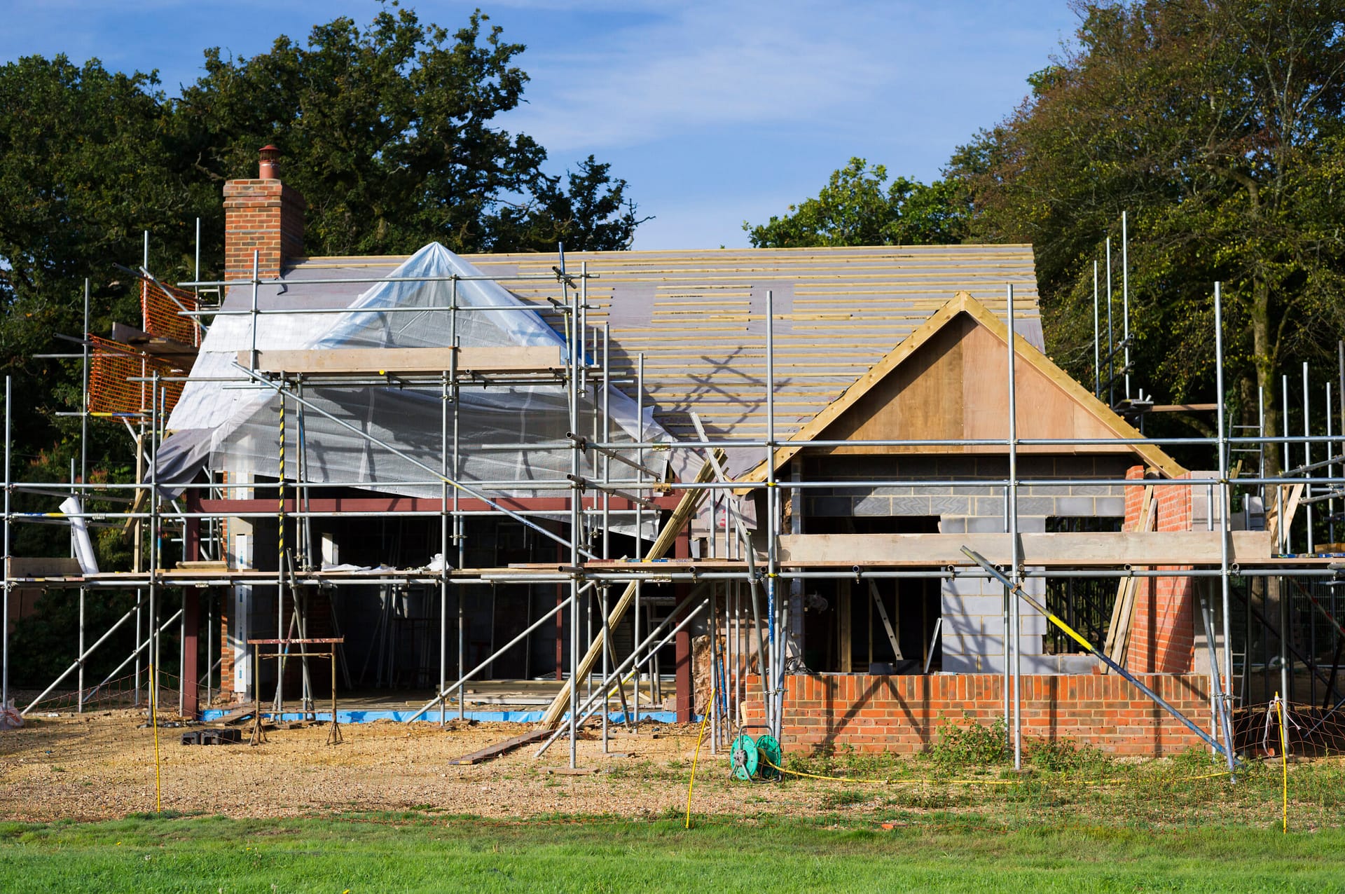 Burley,England,A family home under construction. A building site with scaffolding.